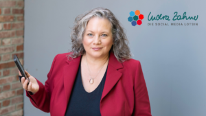 Porträtfoto Indra Zahner, in schwarzem Shirt und roter offener Jacke darüber.